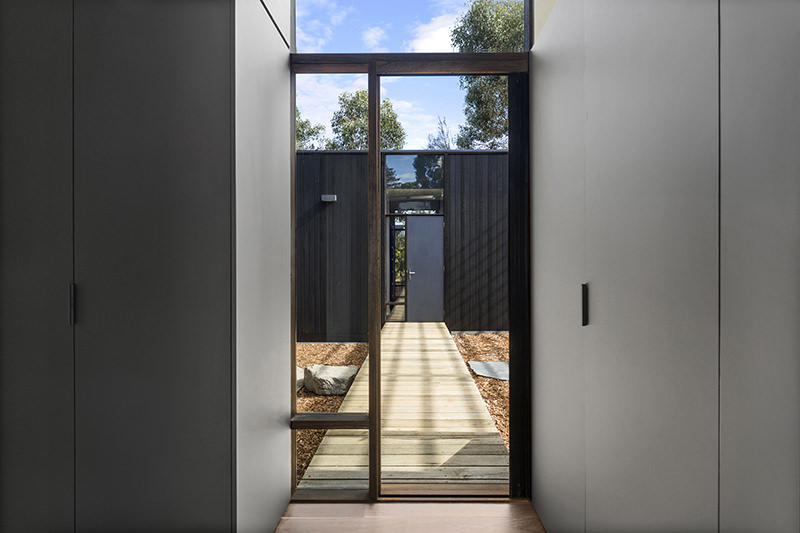 Timber doorway at ARKit's Three Pavilions house